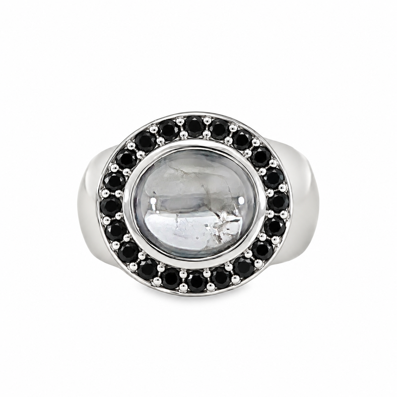 8ct white gold statement ring featuring an oval black spinel cabochon surrounded by a halo of faceted black diamonds, with a wide polished band