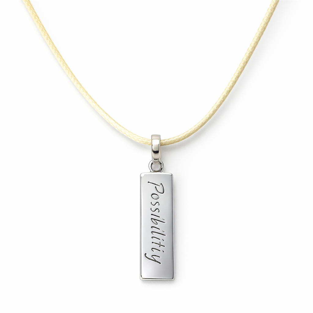 Pendant Tag With "Possibility" Engraved On It On Cream Cord