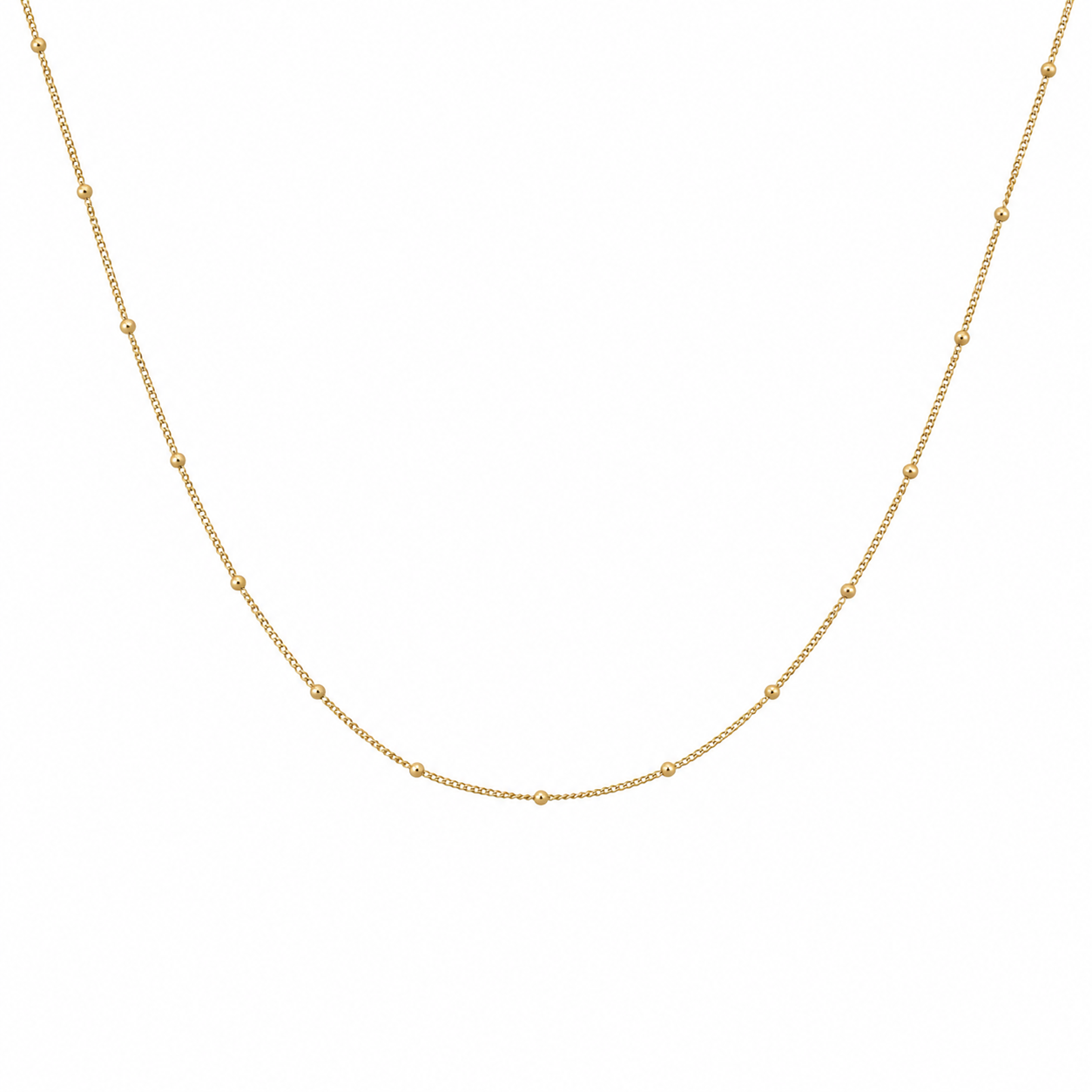 Fine 9k yellow gold curb chain necklace with small polished bead details on a white background