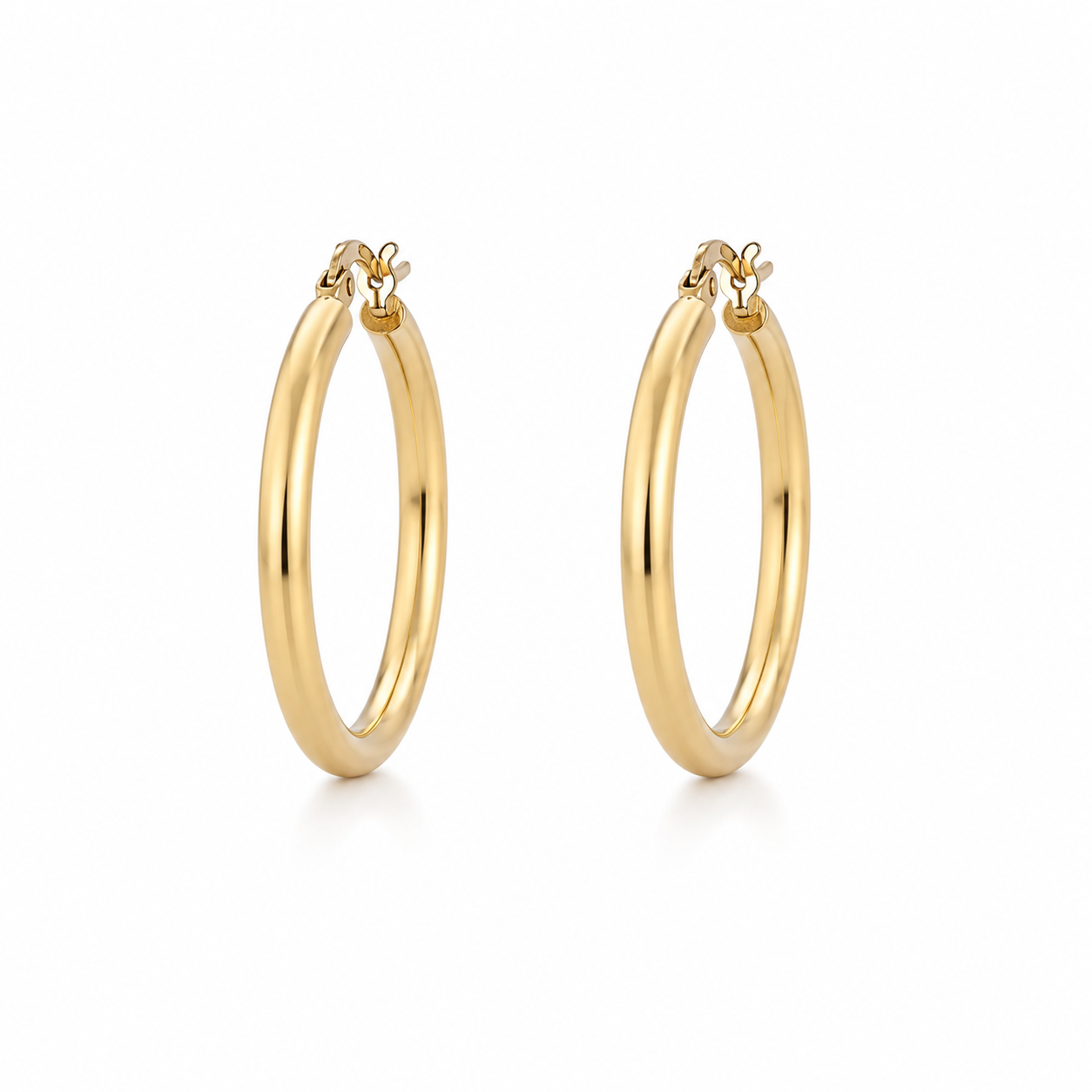 Pair of polished 9k yellow gold hoop earrings measuring approximately 23.5 mm in diameter on a white background