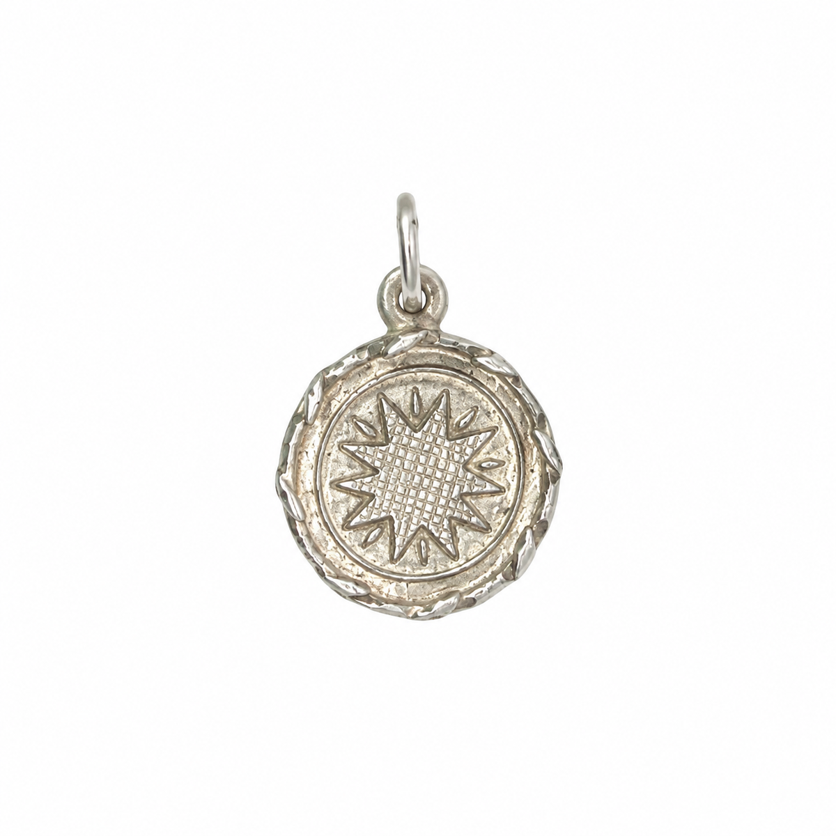 Sterling silver PNG-inspired round starburst pendant with woven centre, approximately 20mm diameter and 2mm thick