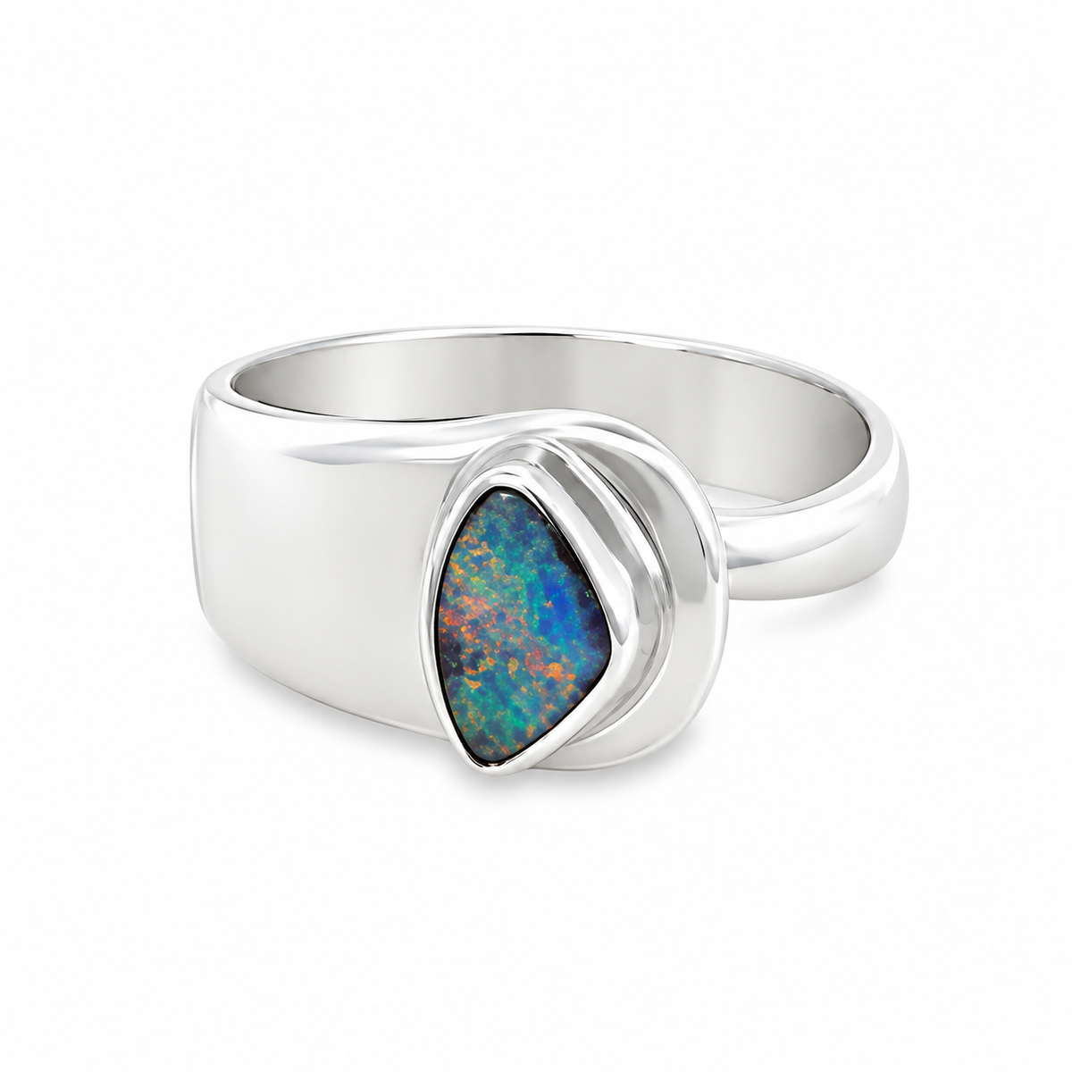 Sterling silver Australian opal ring featuring a freeform blue and green opal in a polished bezel setting with a sculptural asymmetrical band. Jules Collins Jewellery.