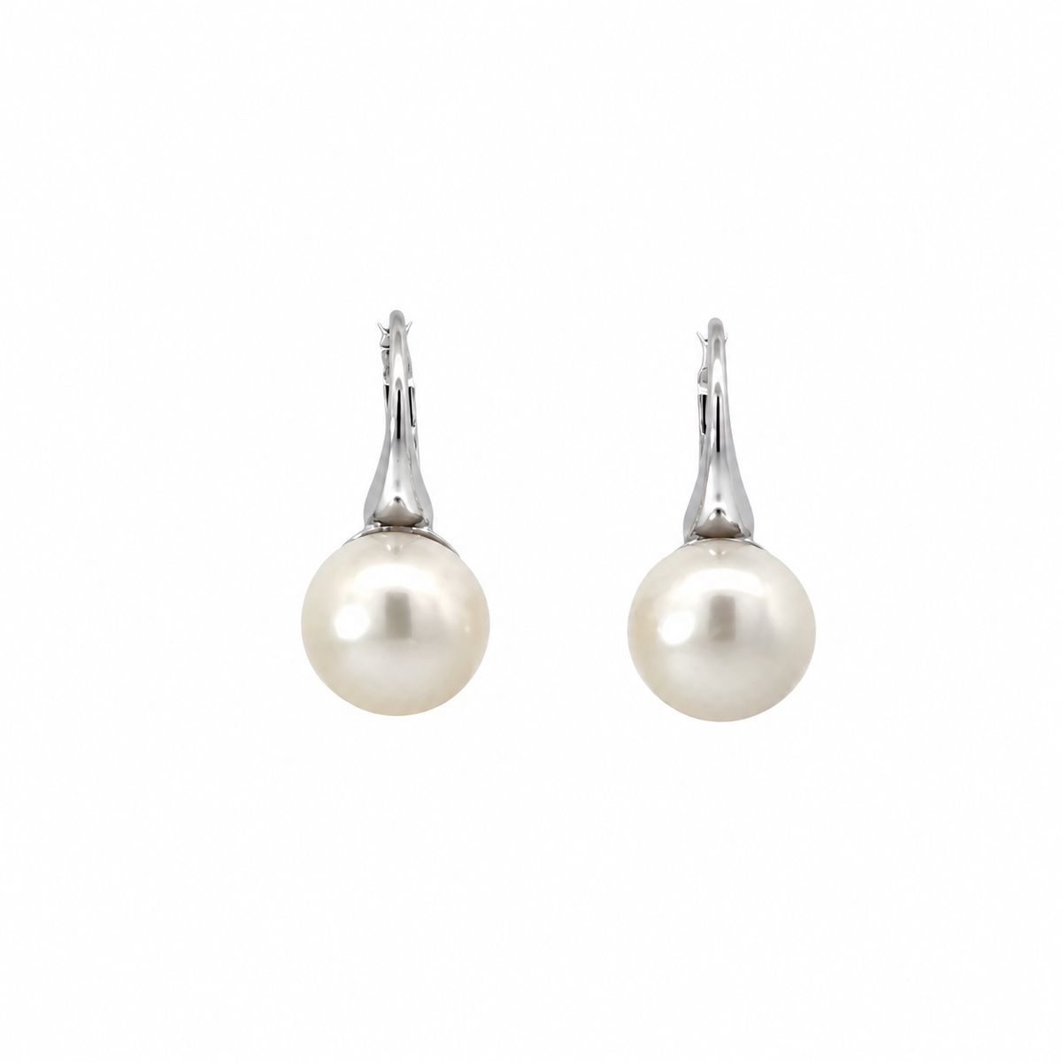 Pair of freshwater pearl earrings with sterling silver leverback closures on a white background