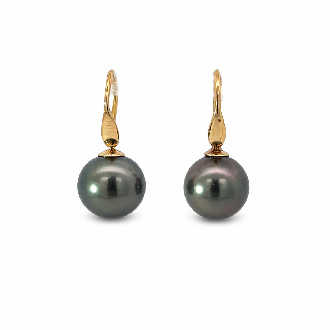 Pair of Tahitian pearl drop earrings with dark round pearls and polished 9K yellow gold hooks on a white background